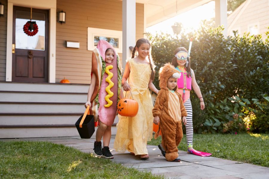 kids with costumes go around at halloween 23737095