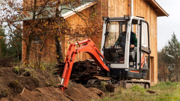 small rental excavator digging trench 506e7587