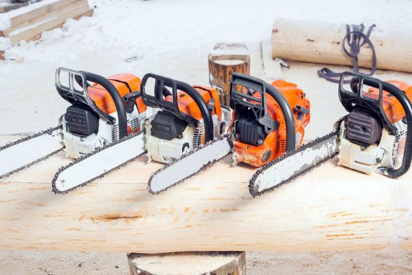 chainsaws sitting on log 5a5eedf7