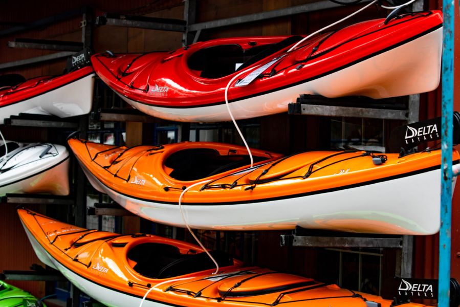 orange kayaks stored in shed 609dd9e8