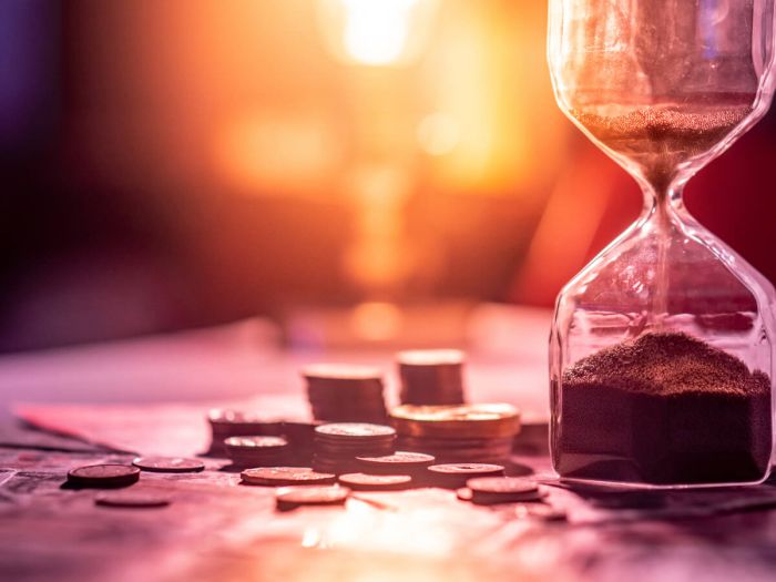 hour glass and money on table 62d2a5a4