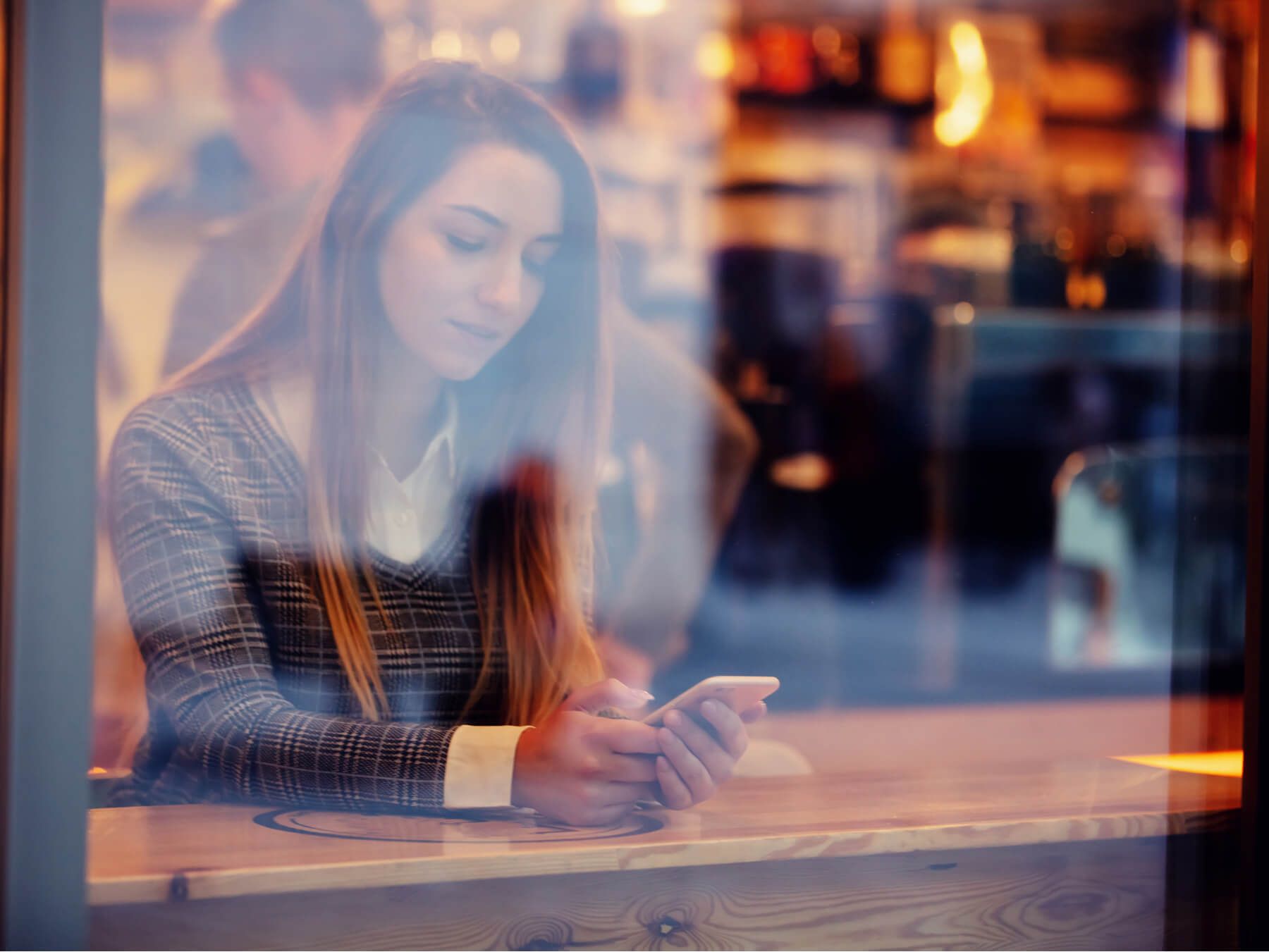 girl with a mobile phone in a cafe 72808b97