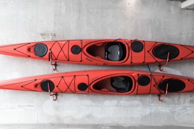 two kayaks stored on wall 79cc0d3c